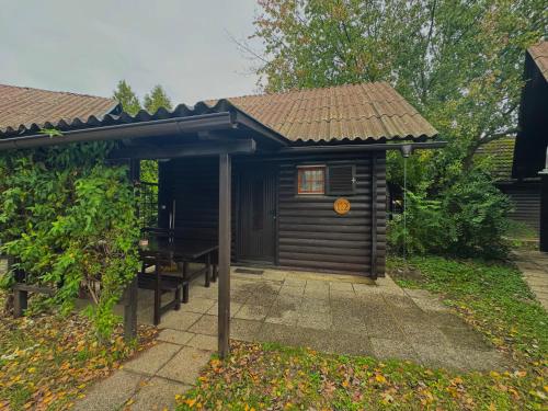 a small cabin with a table and a roof at Teddy in Čatež ob Savi