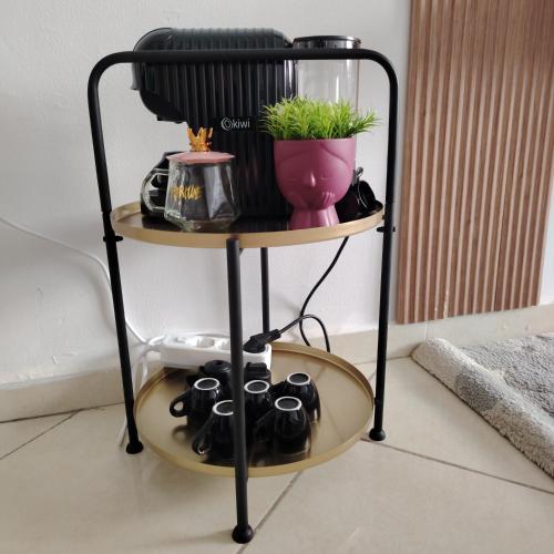 a shelf with pots and a plant on it at Élégance familiale à Skhirate près de la plage et la ville in Skhirat