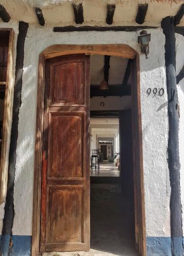 a wooden door in a building with a hallway at Posada la Arcadia in Pedro Gonzalez