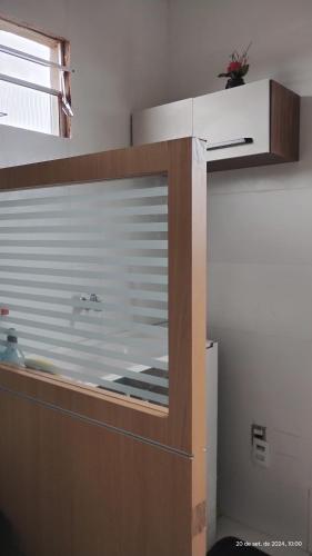 a kitchen with a glass window in a room at New House Temporada in João Pessoa