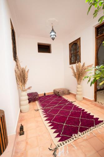 a room with a purple rug on the floor at Dasofinya lodges in Touggana