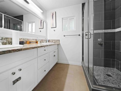 a bathroom with two sinks and a shower at Retreat with Pool in Los Angeles