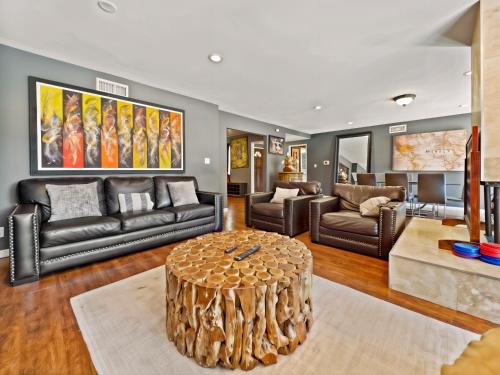 a living room with leather furniture and a coffee table at Retreat with Pool in Los Angeles