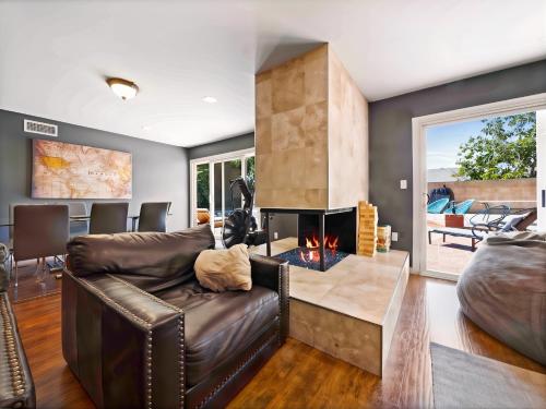 a living room with a couch and a fireplace at Retreat with Pool in Los Angeles