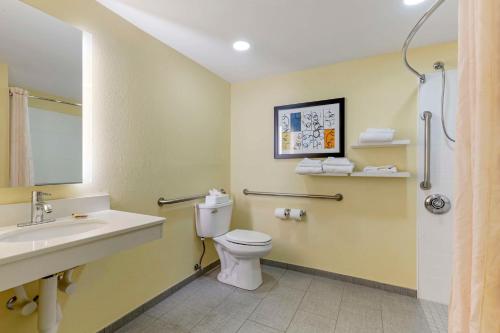 a bathroom with a white toilet and a sink at Best Western Plus North Shore Hotel in Danvers