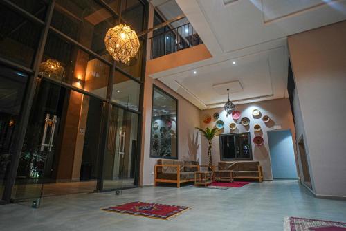 a lobby of a building with a couch and chairs at RIMALIZ House in Amizmiz