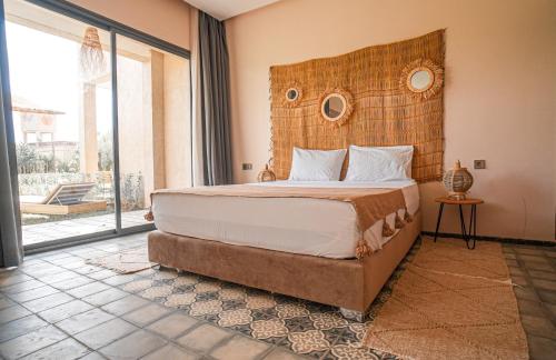 a bedroom with a large bed with a wooden headboard at RIMALIZ House in Amizmiz