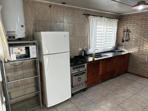 a kitchen with a white refrigerator and a stove at Casa Madison in Casa Grande