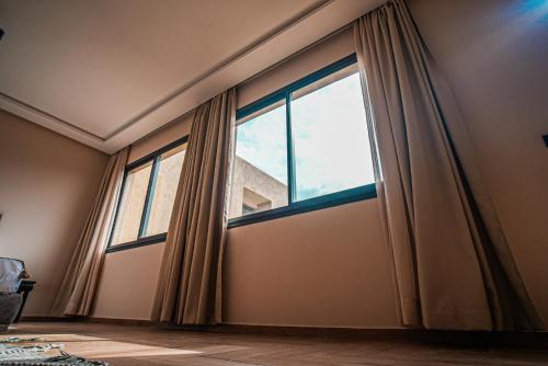 a large window with curtains in a room at RIMALIZ House in Amizmiz