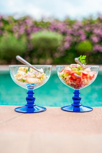 two bowls of food on a table next to a pool at RIMALIZ House in Amizmiz