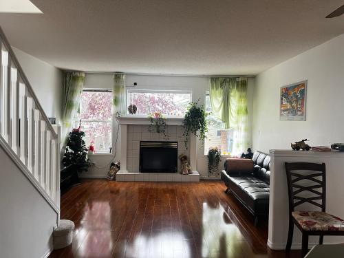 a living room with a couch and a fireplace at hidden valley new basement suite with private bathroom! in Calgary