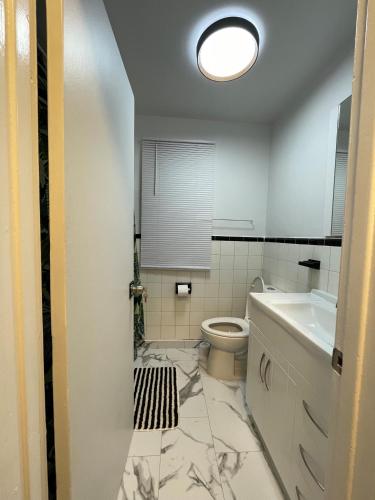 a bathroom with a toilet and a sink at Toronto Full Bed in a Room - Midtown in Toronto