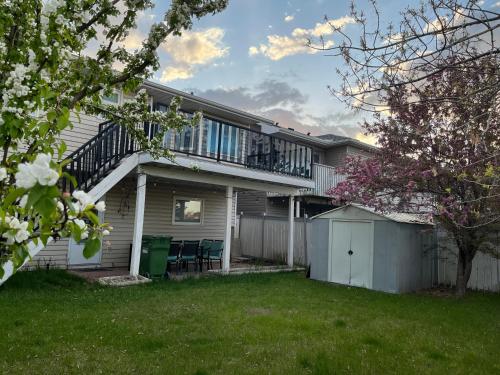 a house with a balcony and a yard at citadel cozy quilt private bedroom in Calgary