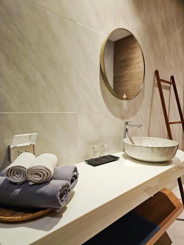 a bathroom with a sink and a mirror on a counter at Siri Lagoona Resort in Nong Prue