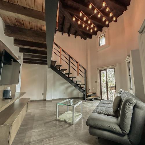 a living room with a couch and a staircase at Hotel Pietro Santo in Santeagueda