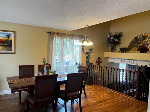 a dining room with a table and chairs at Beautiful room close Airport! in Calgary