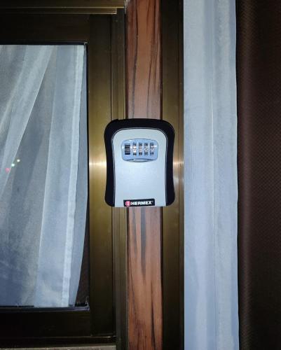 a television on a wall next to a window at Villa Campo's in Venecia