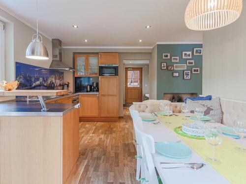 a kitchen and living room with a table and chairs at Schönfeld I in Kitzbühel