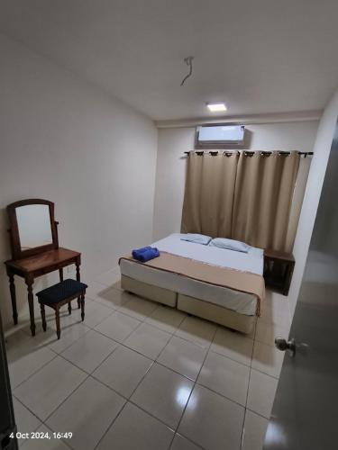 a bedroom with a bed and a chair and a window at Mama Homestay -Near UiTM and Hospital in Bandar Puncak Alam