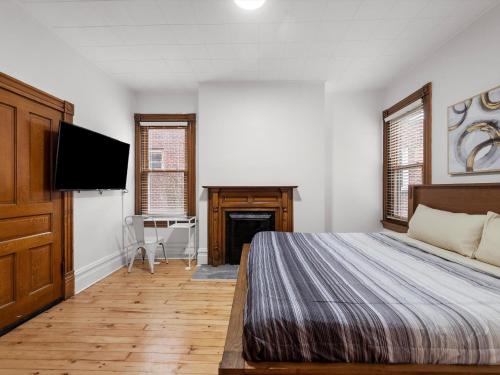 a bedroom with a bed and a flat screen tv at Oakland, Pittsburgh !D Modern and Stylish Private Bedroom with Shared Bathroom in Pittsburgh