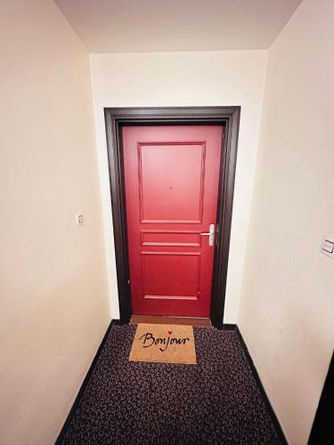 a red door with a box in front of it at SRi-iNDO Bobigny Paris in Bobigny