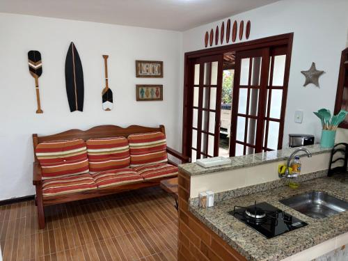 a kitchen with a couch in the corner of a room at Casa Becker - Praia Seca in Araruama