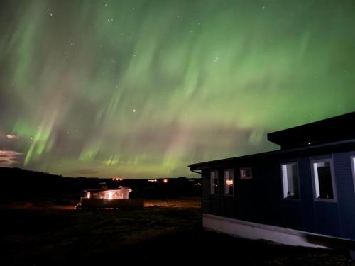 an aurora over a building and a house with a building at Mossberg Luxury 3 bedroom Villa in Selfoss