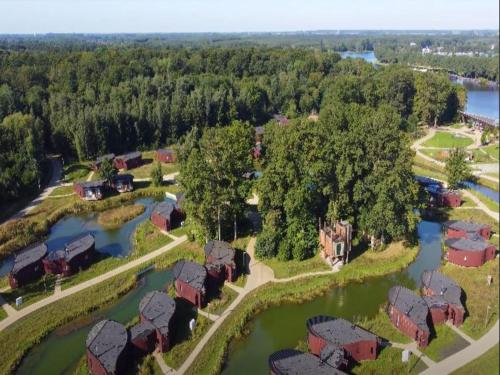 an aerial view of a home next to a river at Forest-Edge Retreat, Antoing in Antoing