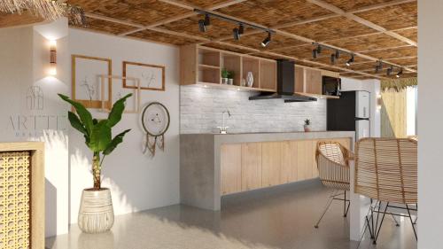 a room with a kitchen with a table and chairs at Acacia Sunset Village Inn in Dauis