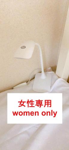 a white lamp sitting on top of a bed at HOSTEL198 Bunk Bed for Female OnlyーVacation STAY68090v in Osaka
