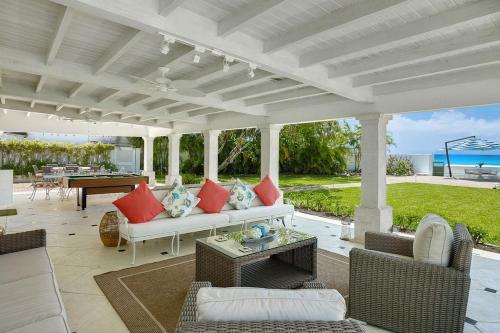 a patio with a couch and chairs and a table at High Trees villa in Saint Peter