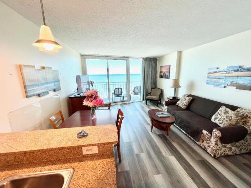 a living room with a couch and a table at Sandy Beach Resort in Myrtle Beach