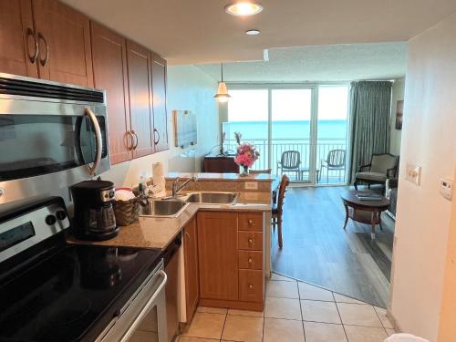 a kitchen with a view of a living room at Sandy Beach Resort in Myrtle Beach