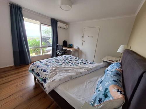a bedroom with a bed and a window at Auyea Farm 3BR Entire House - 7 Mins to Gumbuya World in Tynong North