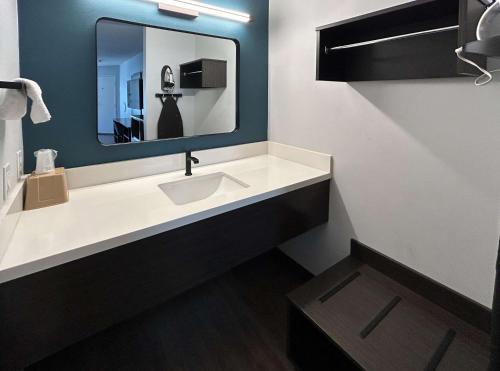 a bathroom with a sink and a mirror at Studio 6 Suites Gardena, CA in Gardena