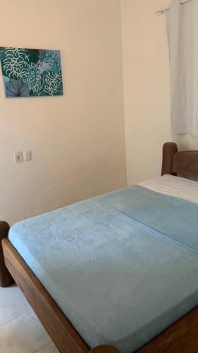 a bed in a room with a picture on the wall at Villa Mahai- casa 1 in Cayru