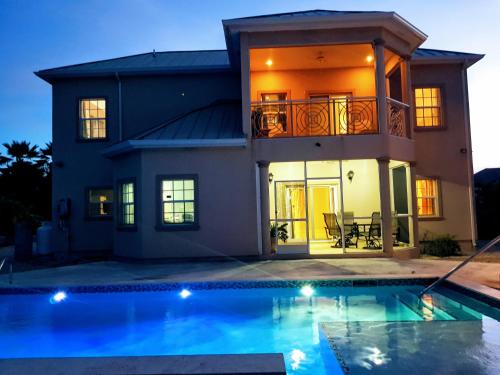a house with a swimming pool in front of a house at Casa de Bells 1 in Prospect Park