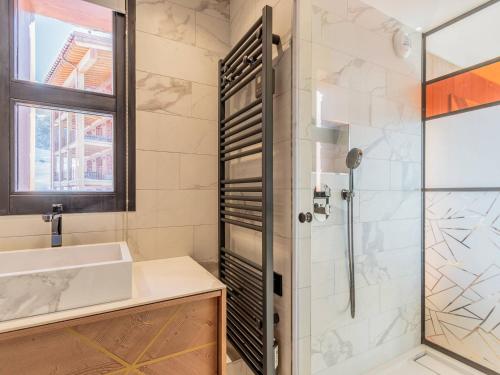 a bathroom with a sink and a shower at Appartement neuf avec terrasse, SPA et parking inclus - 6 pers - FR-1-352-103 in Arc 1800