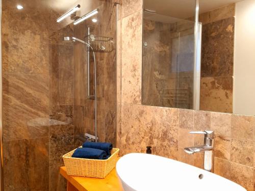 a bathroom with a sink and a shower with a mirror at Escapade nature et patrimoine, près de la Loire - FR-1-590-443 in Tavers