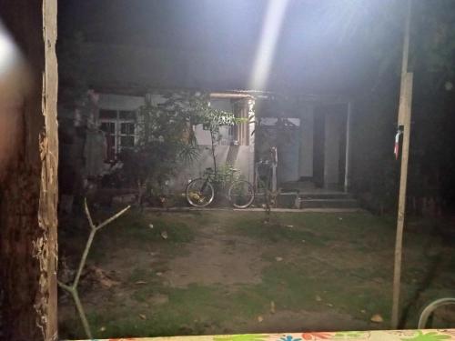 a house with a bike parked in the yard at Blue Luck in Masbagik