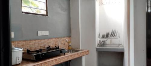 a kitchen counter with a sink and a sink at Villa Aroma Ahangama in Ahangama