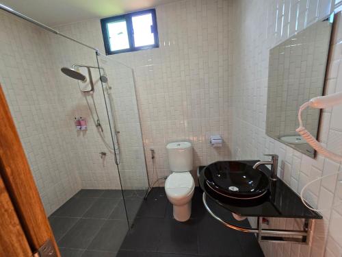 a bathroom with a shower and a toilet and a sink at Riverhill khaoyai homestay in Pong Talong