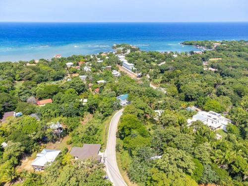 an aerial view of a road in front of the ocean at Luxury 3 Bdrms villa with private-pool and full-concierge in Roatan