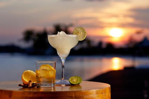 a margarita and a glass with a drink and lemons at Natra Bintan, a Tribute Portfolio Resort in Lagoi