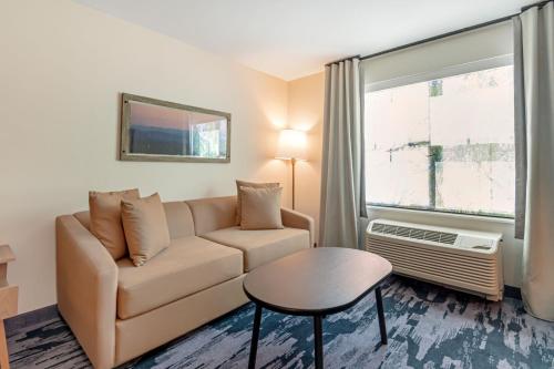 a living room with a couch and a window at Fairfield by Marriott Inn & Suites North Conway in North Conway