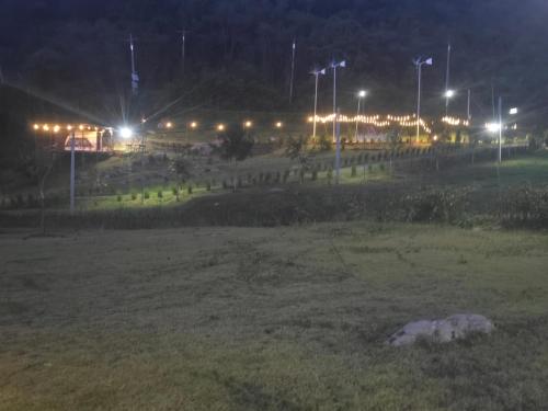 a park at night with lights in a field at Riverhill khaoyai Camping in Pong Talong