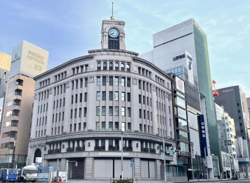 a building with a clock tower on top of it at HOTEL AMANEK Ginza East in Tokyo