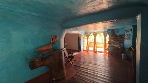 a room with a blue wall and a wooden floor at Suarez Hotel in Diego Suarez