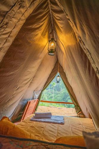 a tent with a light inside of it at Bambara Ella Agro Resort & Camping in Haputale