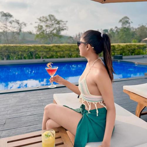 a woman sitting on a table with a drink at The Argyle Luxury Boutique in Hatton